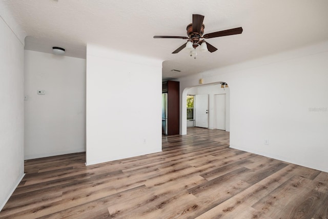 spare room featuring hardwood / wood-style flooring, a textured ceiling, and ceiling fan