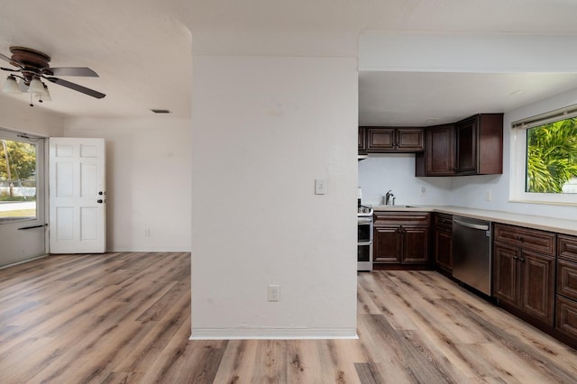 kitchen with appliances with stainless steel finishes, sink, ceiling fan, dark brown cabinetry, and light hardwood / wood-style flooring