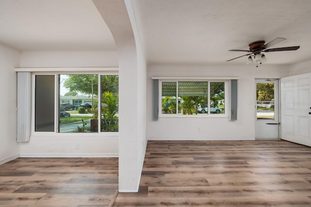 interior space with wood-type flooring and ceiling fan