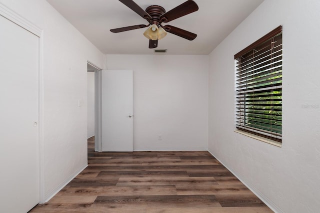 unfurnished bedroom with dark wood-type flooring and ceiling fan