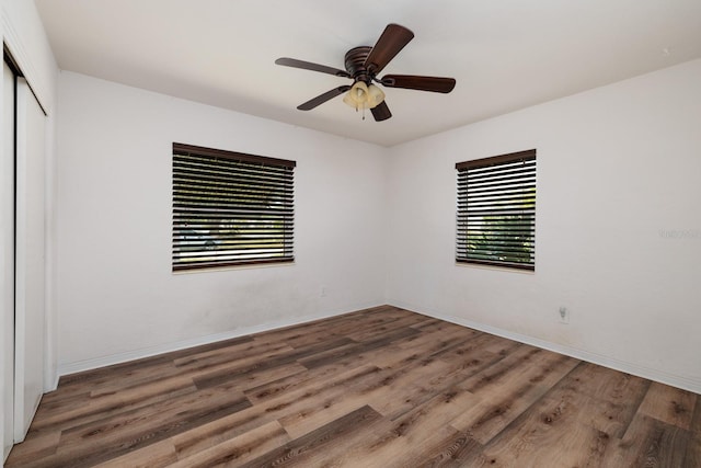 unfurnished room with hardwood / wood-style flooring and ceiling fan