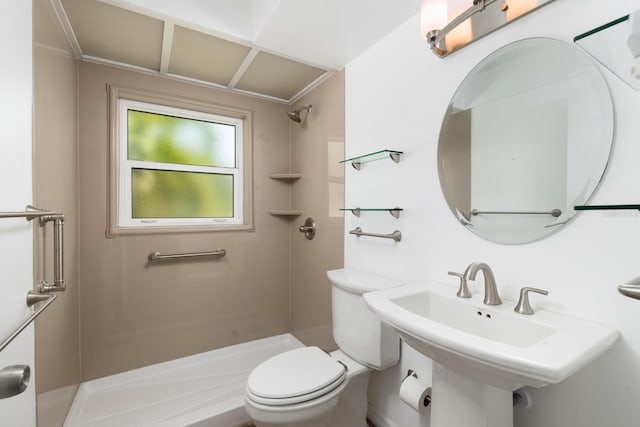 bathroom featuring walk in shower, sink, and toilet