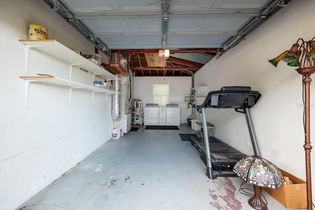 garage featuring water heater and washer and dryer