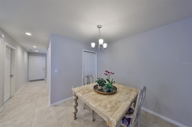 tiled dining space featuring a chandelier