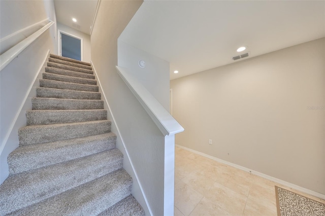 staircase with tile patterned floors