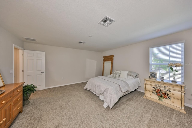 carpeted bedroom with a textured ceiling