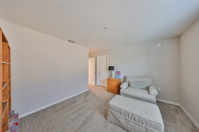 living area featuring light colored carpet