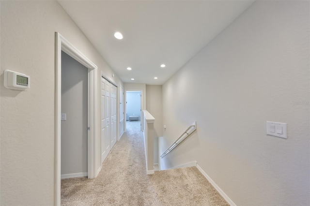 hall featuring light colored carpet