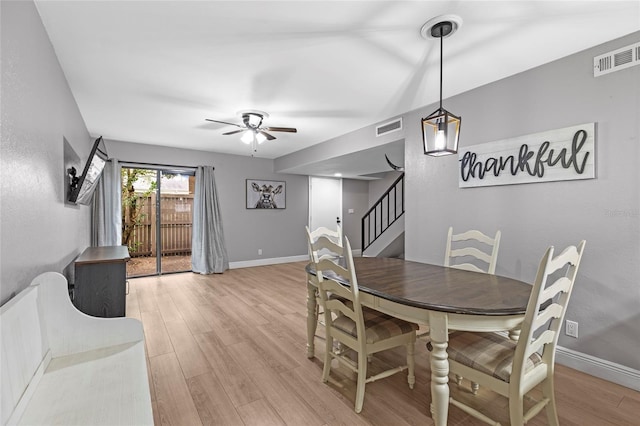 dining area with ceiling fan and light wood-type flooring