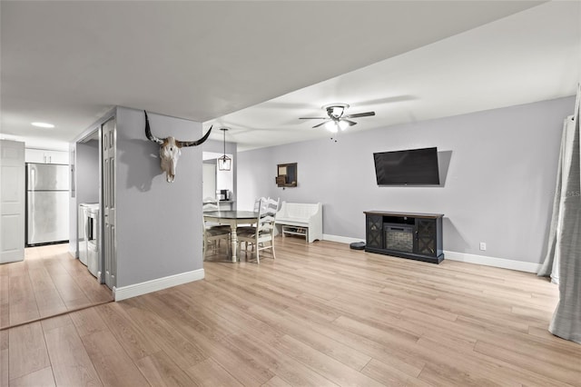 unfurnished living room with ceiling fan and light hardwood / wood-style flooring