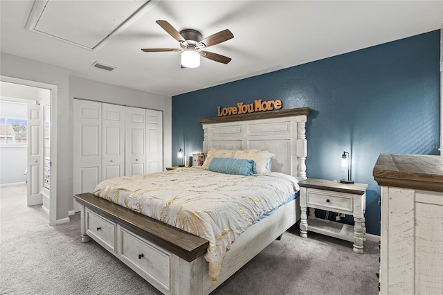 carpeted bedroom with ceiling fan and a closet