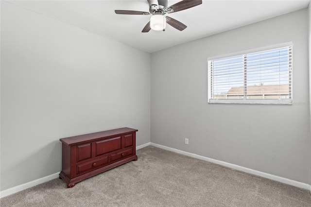 spare room featuring ceiling fan and light colored carpet