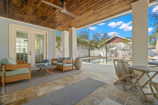 view of patio / terrace featuring a fenced in pool, french doors, and ceiling fan