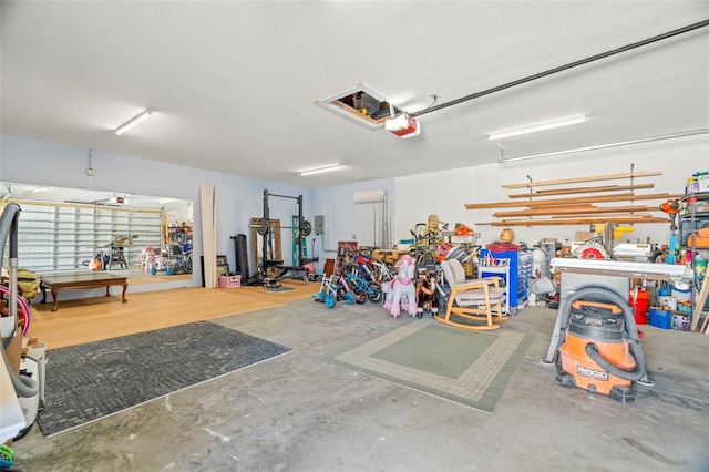 garage with a garage door opener and a workshop area