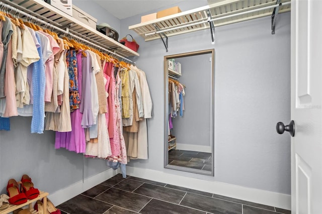 spacious closet with dark tile patterned flooring