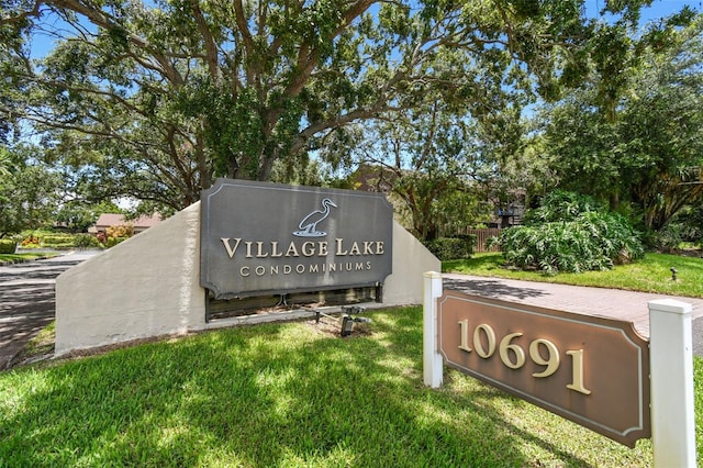 community / neighborhood sign featuring a lawn