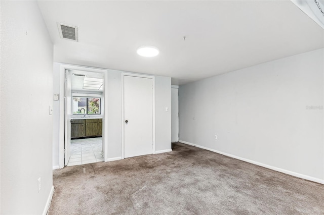 880 S Village Lake Dr N Unit 106, Saint Petersburg, FL 33716 - unfurnished bedroom featuring light carpet and ensuite bathroom