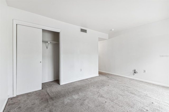 880 S Village Lake Dr N Unit 106, Saint Petersburg, FL 33716 - unfurnished bedroom featuring carpet floors and a closet
