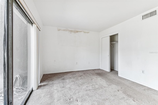 880 S Village Lake Dr N Unit 106, Saint Petersburg, FL 33716 - unfurnished bedroom with light carpet and a closet