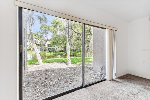 880 S Village Lake Dr N Unit 106, Saint Petersburg, FL 33716 - doorway to outside featuring carpet floors, a water view, and a wealth of natural light