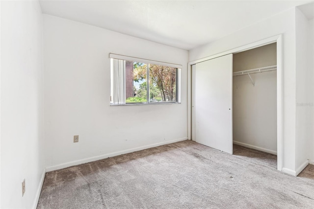 880 S Village Lake Dr N Unit 106, Saint Petersburg, FL 33716 - unfurnished bedroom featuring light carpet and a closet