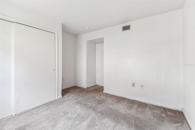 880 S Village Lake Dr N Unit 106, Saint Petersburg, FL 33716 - unfurnished bedroom featuring light carpet and a closet