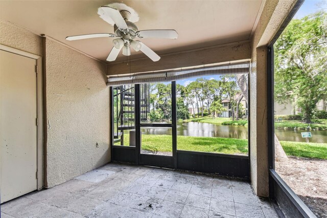 880 S Village Lake Dr N Unit 106, Saint Petersburg, FL 33716 - unfurnished sunroom featuring a water view and ceiling fan