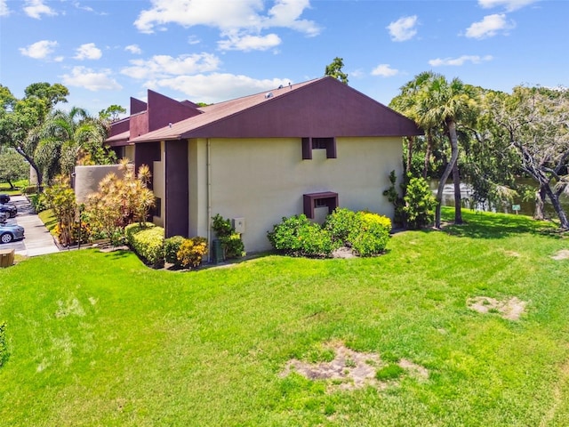 880 S Village Lake Dr N Unit 106, Saint Petersburg, FL 33716 - view of side of property with a yard