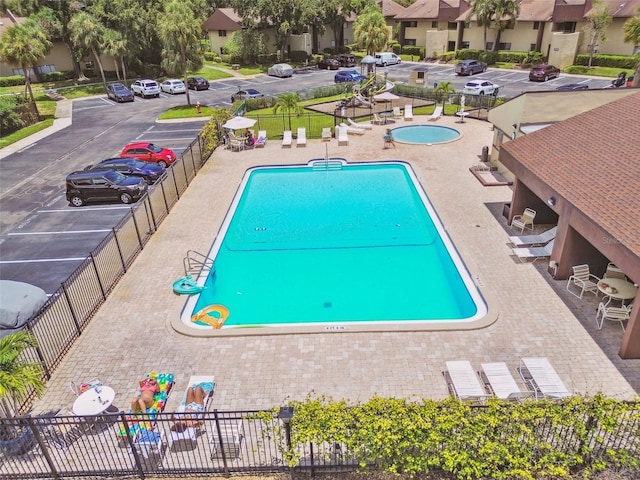 880 S Village Lake Dr N Unit 106, Saint Petersburg, FL 33716 - view of swimming pool with a patio
