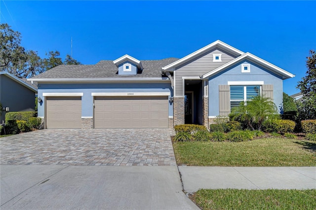 view of front of property featuring a garage and a front lawn