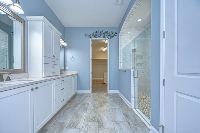 bathroom featuring vanity and a shower with shower door