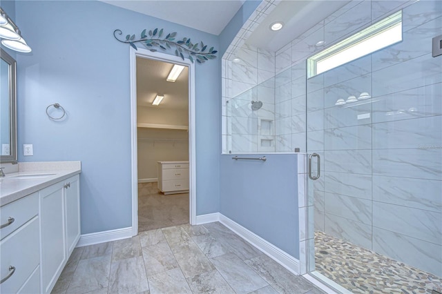 bathroom with vanity and a shower with door