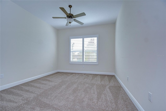 unfurnished room featuring light colored carpet and ceiling fan