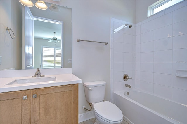 full bathroom featuring vanity, tiled shower / bath combo, a wealth of natural light, and toilet