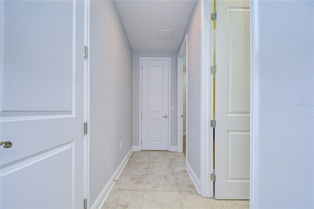 corridor featuring light tile patterned floors