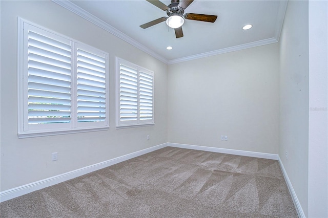 unfurnished room featuring crown molding, plenty of natural light, light colored carpet, and ceiling fan