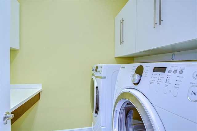 laundry area featuring cabinets and independent washer and dryer