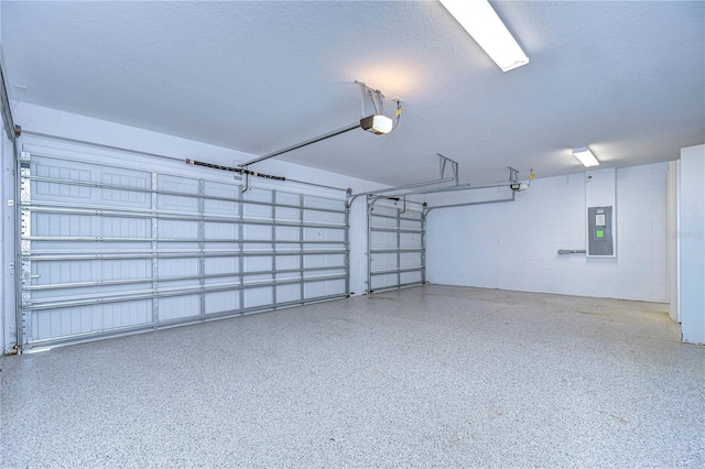 garage with a garage door opener and electric panel