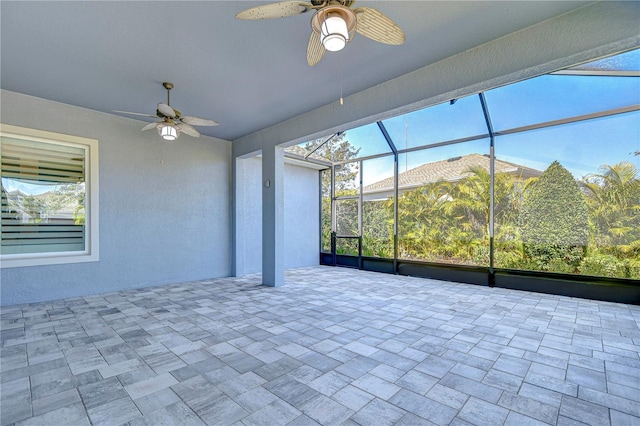 unfurnished sunroom with plenty of natural light and ceiling fan