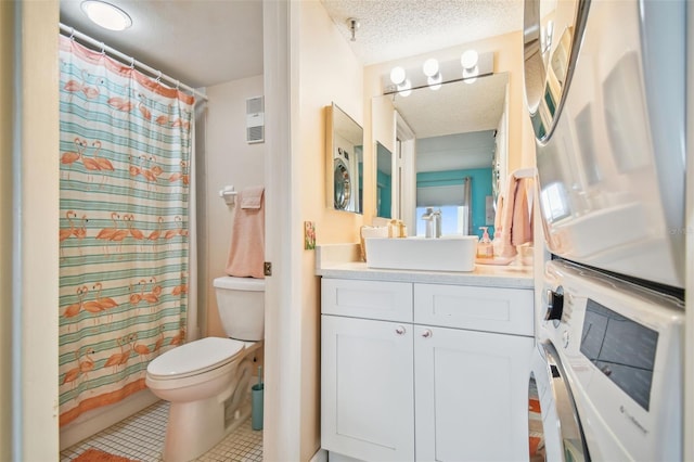 bathroom with a shower with shower curtain, vanity, a textured ceiling, tile patterned floors, and toilet