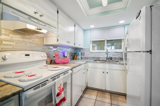 kitchen featuring white cabinetry, white appliances, a tray ceiling, and sink