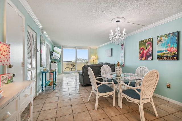 dining space featuring ornamental molding, light tile patterned floors, a notable chandelier, and a textured ceiling