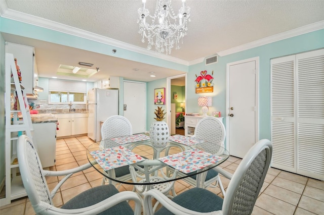 dining room with crown molding, light tile patterned floors, a textured ceiling, and an inviting chandelier