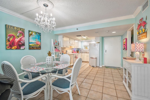 dining space with crown molding, light tile patterned floors, and a textured ceiling