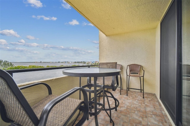 balcony featuring a water view