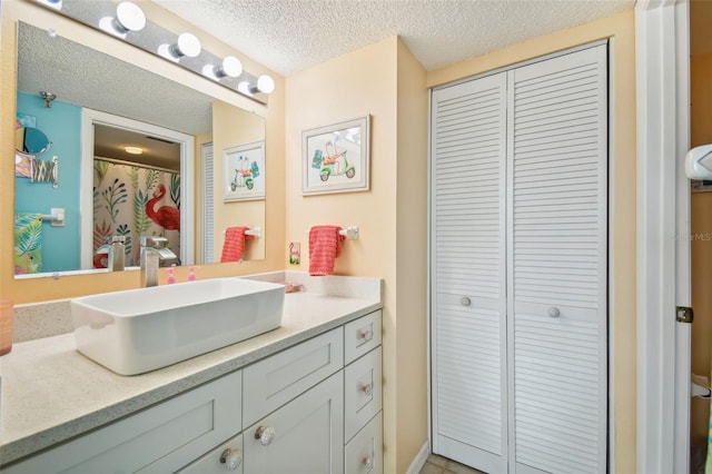 bathroom featuring vanity and a textured ceiling