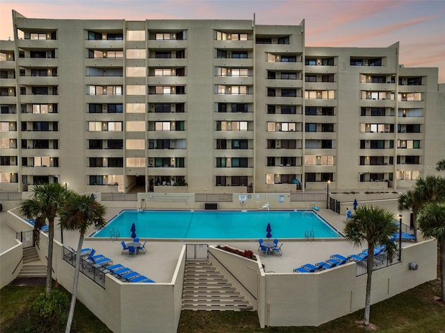 view of pool at dusk