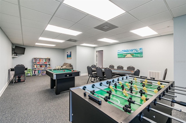 recreation room featuring a drop ceiling and carpet floors