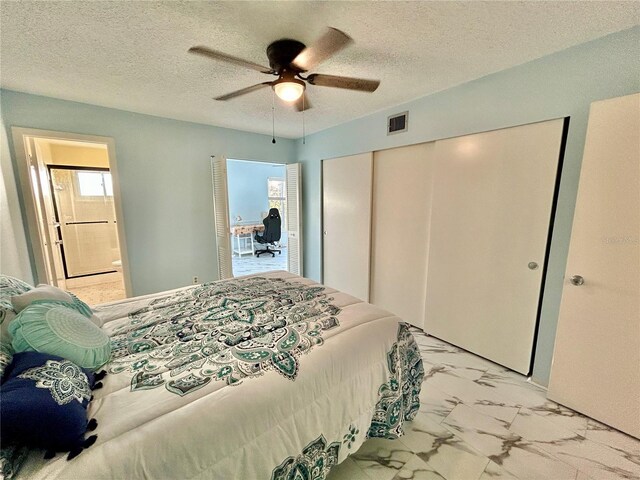 bedroom with multiple windows, a closet, and a textured ceiling