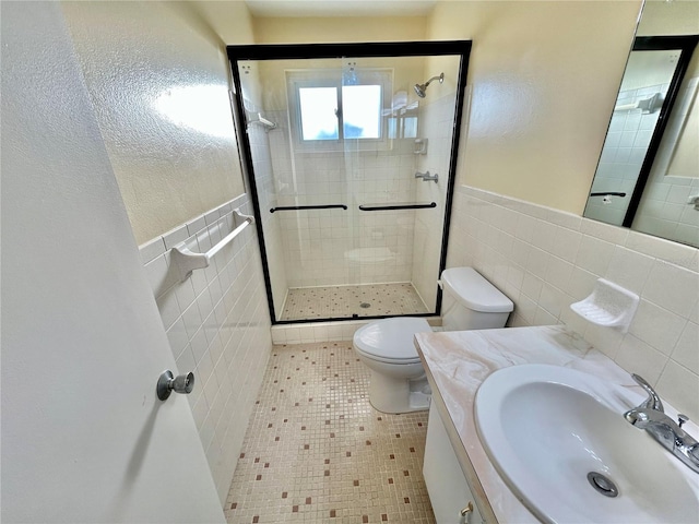 bathroom with walk in shower, tile patterned floors, toilet, tile walls, and vanity